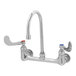 A chrome T&S wall mounted medical faucet with 2 wrist action handles.