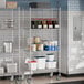 Steelton NSF chrome wire shelving with casters in a kitchen with food containers.