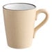 A tan stoneware mug with a handle and black rim.