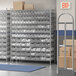 A Regency wire shelving unit with clear plastic bins on the shelves.
