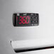 A digital display with red numbers on a stainless steel Beverage-Air reach-in refrigerator.