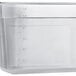 A Vigor translucent polypropylene food pan on a counter.