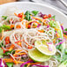 A bowl of sweet potato noodles with vegetables.