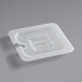 A close-up of a translucent plastic container with a handled lid and notch in the middle.