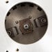 The short upper housing for a Hobart commercial garbage disposer, a circular metal object with a hole in it and screws.