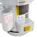The upper part of a Hobart commercial garbage disposer with a small electric motor.