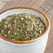 A bowl of Regal Spaghetti Seasoning on a wood surface.