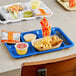 A blue Choice heavy-duty melamine compartment tray with food and drinks on it.