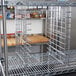 Metro chrome tray slides on a metal rack in a kitchen.