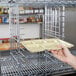 A hand using Metro tray slides on a counter.