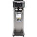 A silver and black Bunn CW15-APS pourover coffee maker on a counter.