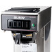 A Bunn CW15-APS pourover coffee maker on a counter with a label and buttons.