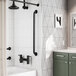 A 36-inch matte black grab bar with a snap flange installed vertically on a bathroom wall.