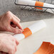 A person using Rust self-adhering paper napkin band.