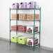 A Metroseal wire shelf with white and green boxes on it.