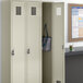 A Regency beige locker unit with three wide lockers.