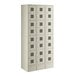 A beige metal Regency locker with twelve small doors.