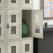 A beige Regency school locker with a green backpack inside.