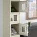 A Regency beige single tier locker with shoes and a hat on top.