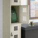 A Regency single locker with a green backpack inside.