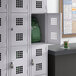 A Regency gray school locker with a green backpack inside.