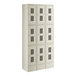 A beige metal Regency locker with many doors.