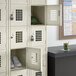 A beige Regency locker with shoes and a hat in it.