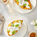 A plate with a sweet potato topped with Follow Your Heart Vegan Sour Cream and cilantro.