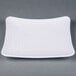 A white square plate with a spiral pattern.