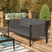 A Flash Furniture charcoal loveseat with storage pockets and a glass table on a deck.