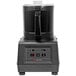 A Sammic black batch bowl food processor on a white base.