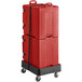 A red trolley with two CaterGator red plastic pan carriers on it.