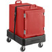A red CaterGator insulated food pan carrier on a black cart.