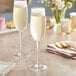 Two Della Luce Maia champagne flute glasses on a table.