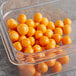 A plastic container of round orange Fresh Peeled Golden Berries.