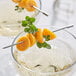 A close up of a skewer of fresh golden berries.