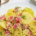 A plate of fresh gold beets on a table.