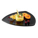 A GET Black Elegance Triangle Plate with food and fruit on it.