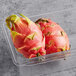 Two Fresh Pink Dragon Fruit in a plastic container.