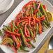 A plate of asparagus and Fresh Greenhouse red bell peppers.