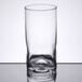 A close-up of a Libbey clear customizable cooler glass on a reflective surface.