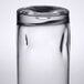 A close-up of a Libbey customizable cooler glass on a table in a bar.