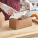 A person opening a Choice Cornerstone print take-out box of food.