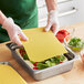 A person putting Barilla lasagna in a pan.