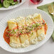 A white plate of Barilla Manicotti pasta with sauce.