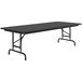 A rectangular black Correll folding table with black legs.