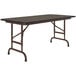 A brown rectangular Correll folding table with metal legs.