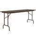 A brown rectangular Correll folding table with a metal frame.