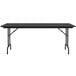 A black Correll rectangular folding table with black legs.