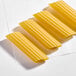 A set of uncooked Barilla Manicotti pasta tubes arranged in a row on a white surface.